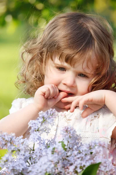 Curly girl with flowers — Stock Photo, Image