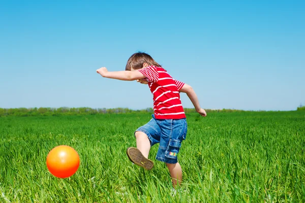 Boy kicking ball — Stock Photo, Image