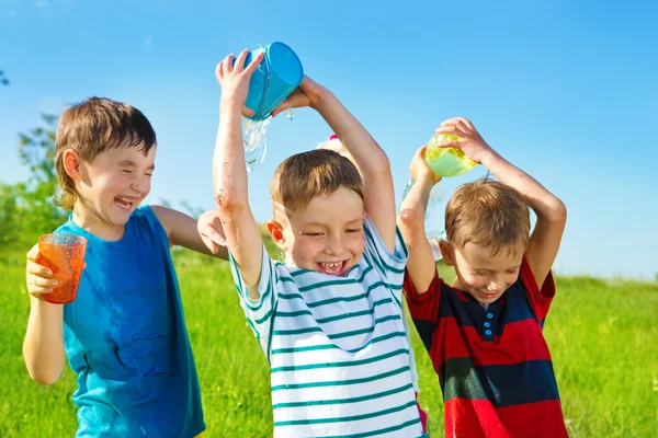 Preschool boys pouring water — Stock Photo, Image