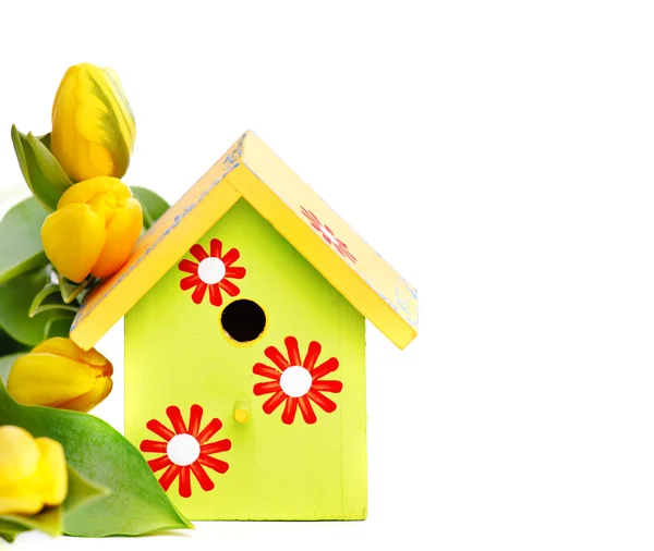 Nestbox and yellow tulips — Stock Photo, Image