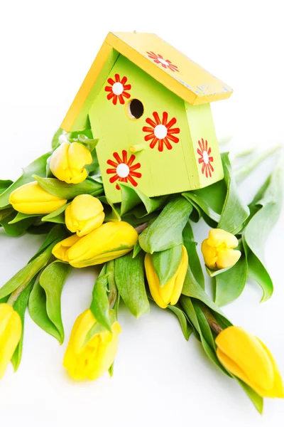 Bird house on flowers — Stock Photo, Image