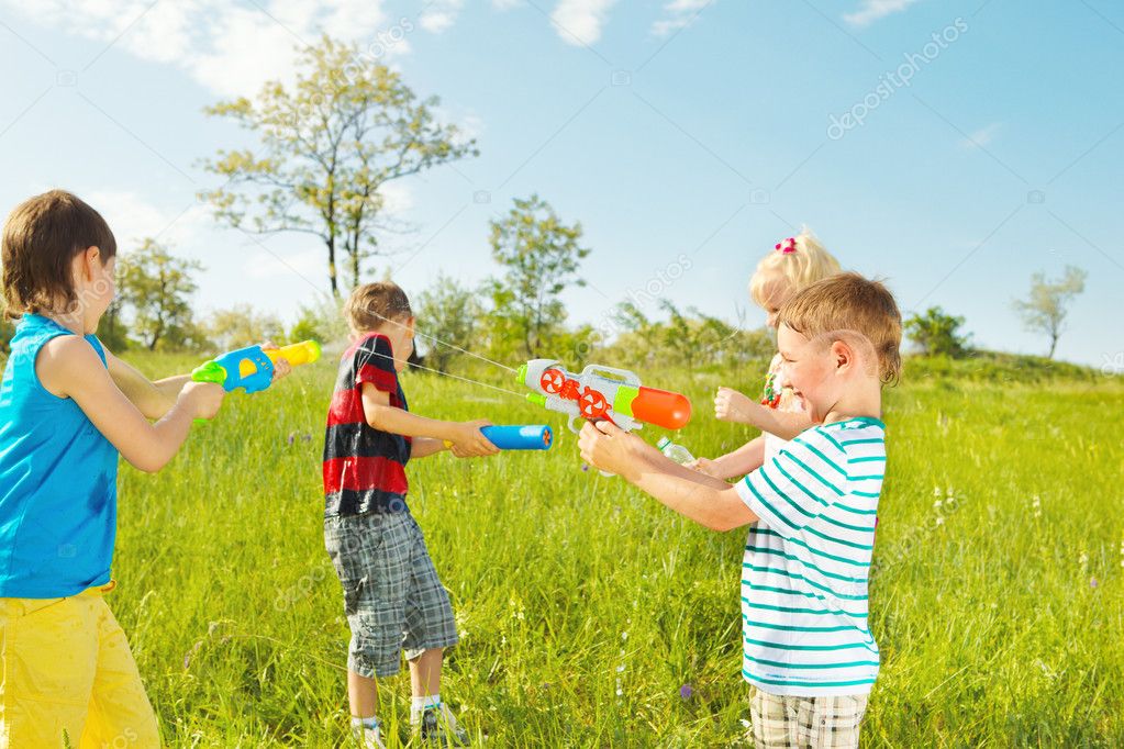 Kids group with water guns and soakers
