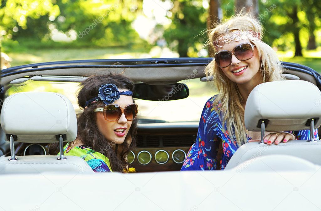 Smiling women in a cabrio