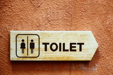 Toilet sign on color wall clipart