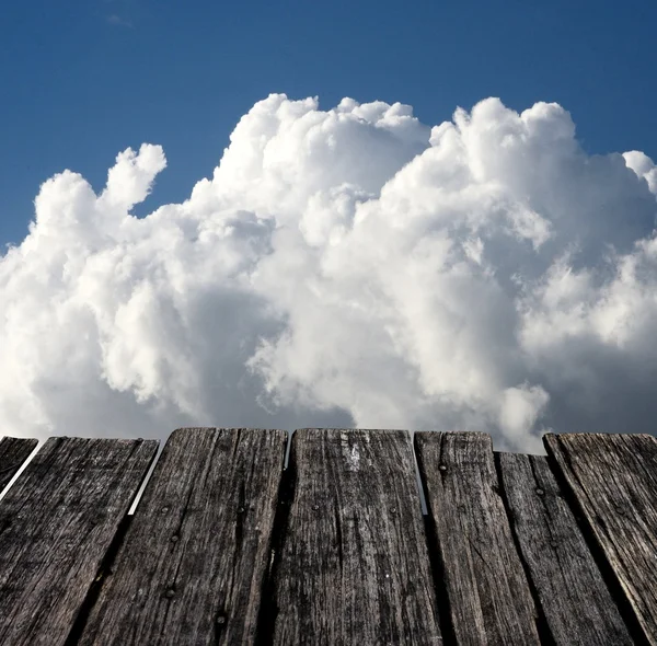 stock image Grunge wooden table with nice cloud sky background