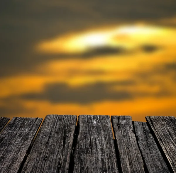 Grunge wooden table with nice sunset sky background