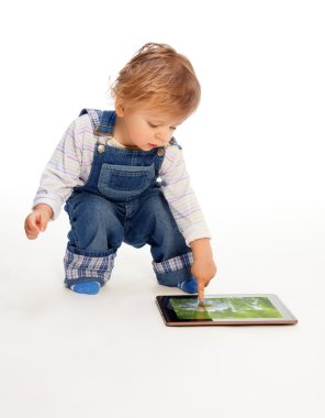 Young kid touching tablet pc clipart