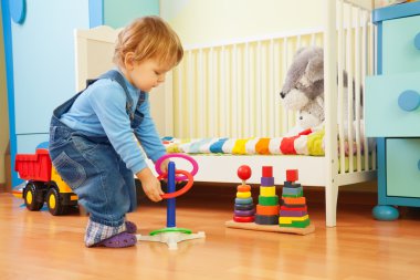 Boy playing with stacking rings clipart