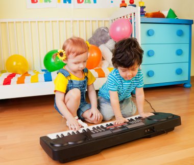 Boy and girl playing a musical instrument clipart