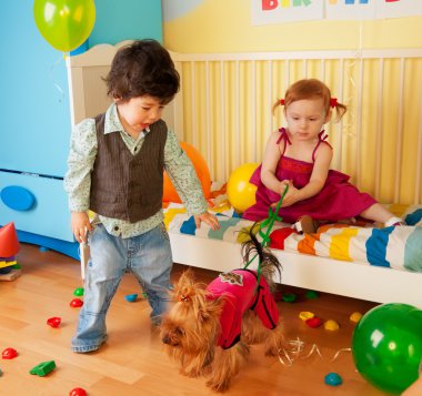 Kids playing with dog and having party clipart