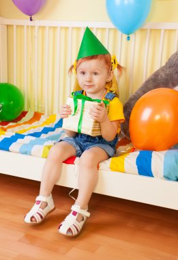 Happy little girl with present clipart