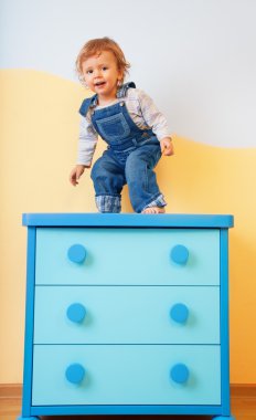 Toddler jumping from furniture clipart