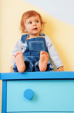 Kid sitting on furniture clipart