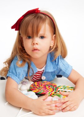 Greedy girl with pile of sweets clipart