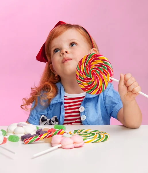 Thoughtful girl with lollipop — Stock Photo, Image