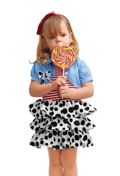 Small girl standing with lollipop — Stock Photo, Image