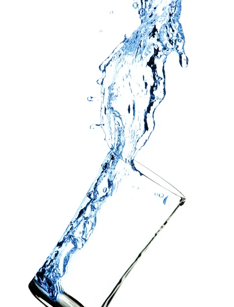 Water splashing out of glass with water — Stock Photo, Image