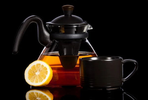 stock image Tea in transparent glass pot with lemon