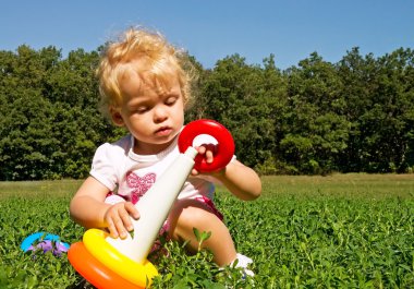 Little girl collects pyramid clipart