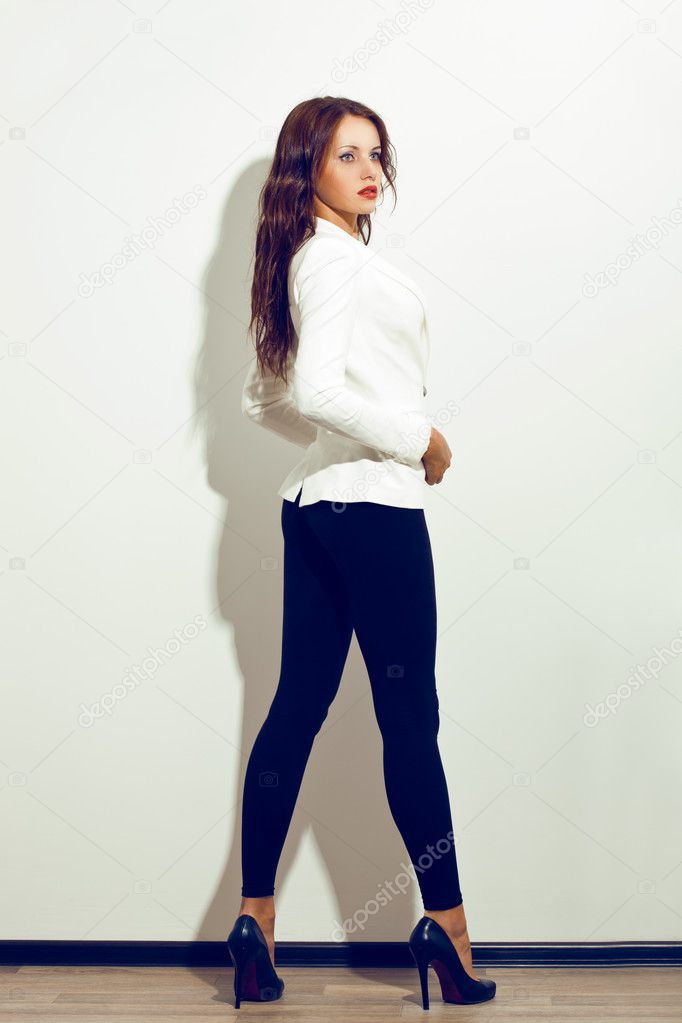 Woman posing over white wall