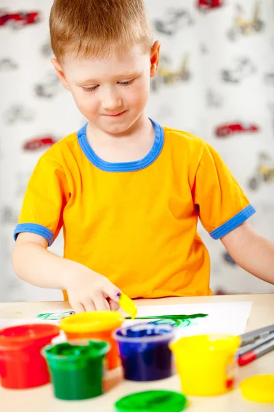 Boy finger paints on paper — Stock Photo, Image