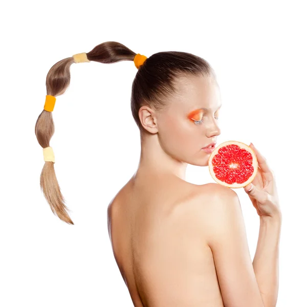 Beautiful woman with grapefruit and creative hairstyle — Stock Photo, Image