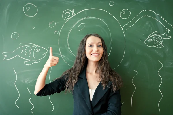 Girl over chalkboard with funny picture — Stock Photo, Image