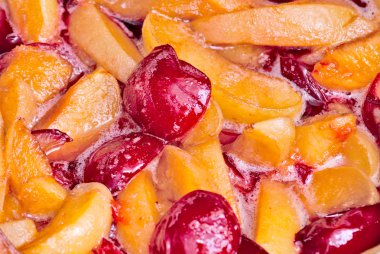 Cooking jam from apricots and plums clipart