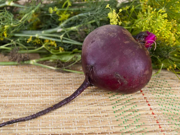 Beet on a table near greens — Stock Photo, Image