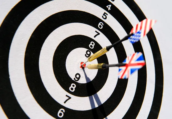 stock image Dartboard with two darts in a bullseye