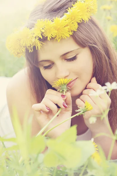 stock image Woman sniffs a dandelion