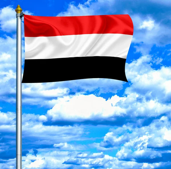 Jemen zwaaien vlag tegen blauwe hemel — Stockfoto