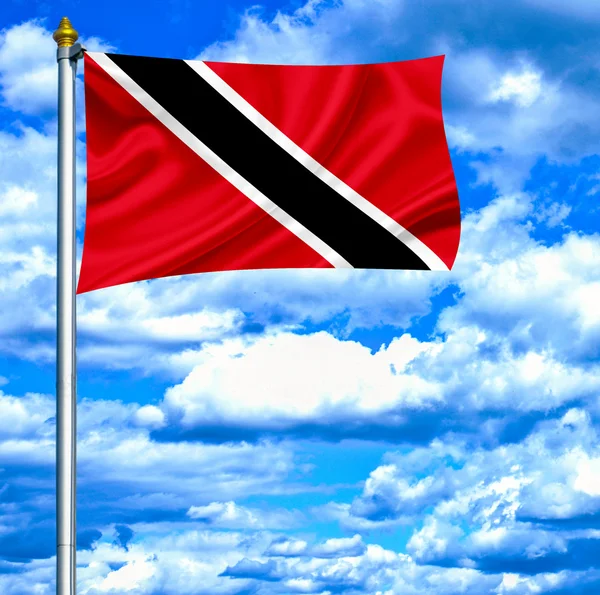 Trinidad en tobago zwaaien vlag tegen blauwe hemel — Stockfoto