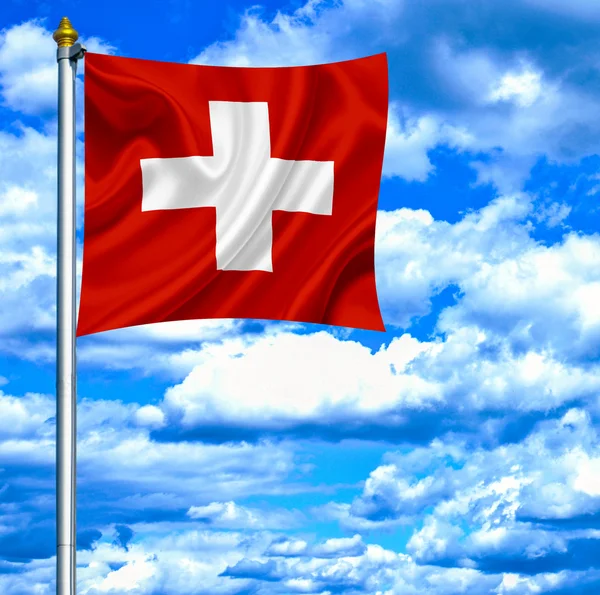 Swiss mává vlajkou proti modré obloze — Stock fotografie