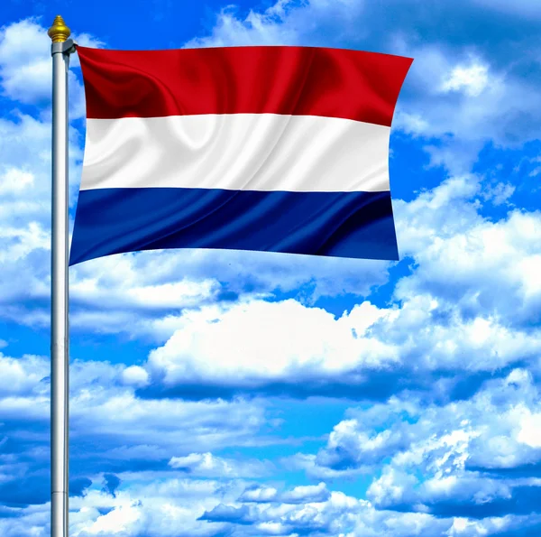 Holland viftande flagga mot blå himmel — Stockfoto