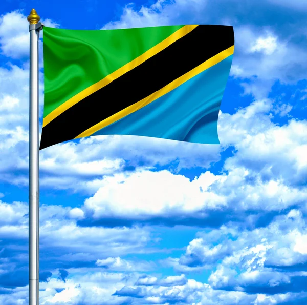 Tanzania waving flag against blue sky — Stock Photo, Image