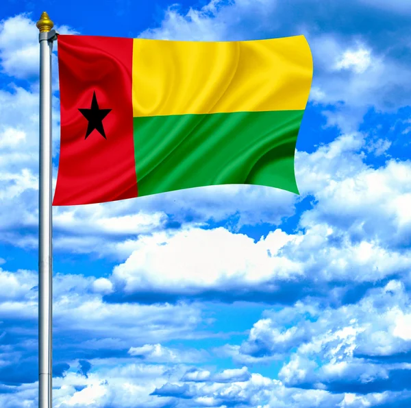 Guinea Bissau waving flag against blue sky — Stock Photo, Image