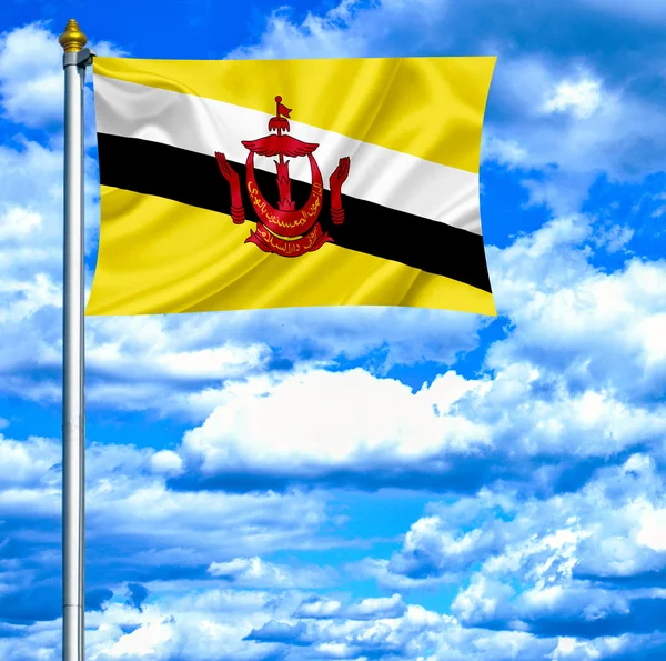 Брунейський розмахуючи прапором проти синього неба — стокове фото