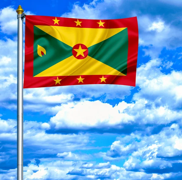 Grenada zwaaien vlag tegen blauwe hemel — Stockfoto