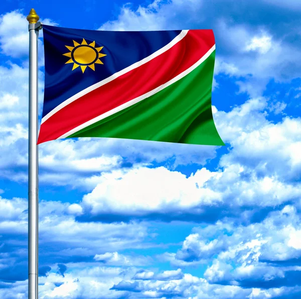 Namibia viftande flagga mot blå himmel — Stockfoto