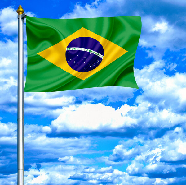 Brazil waving flag against blue sky