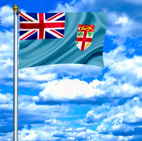Fidži mává vlajkou proti modré obloze — Stock fotografie