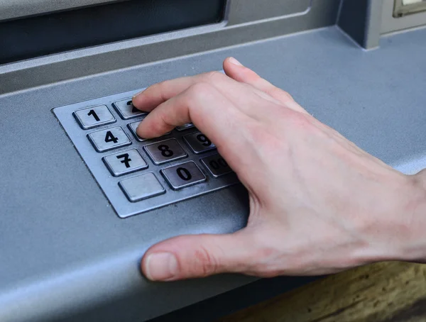 stock image Hand entering numbers on ATM machine