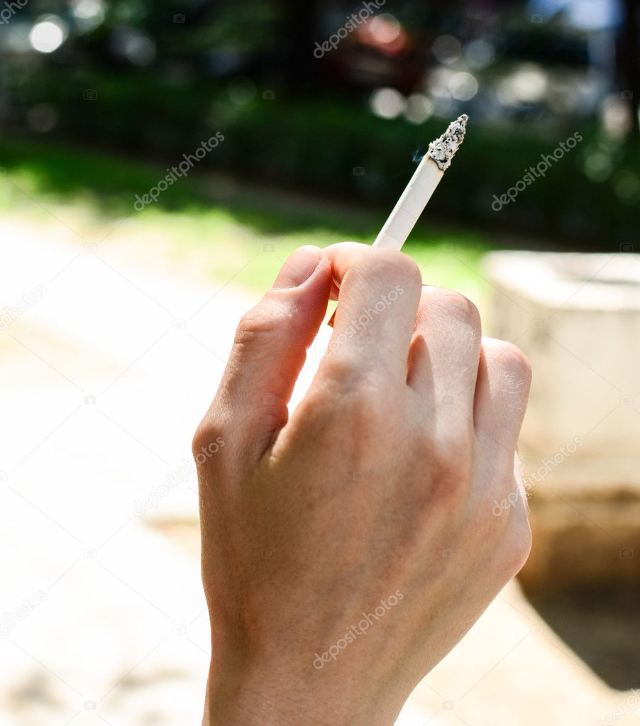 Woman hand holding a cigarette