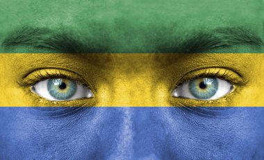 Human face painted with flag of Gabon clipart