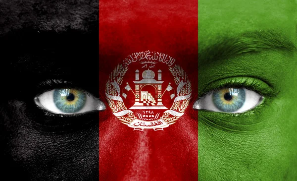 Human face painted with flag of Afghanistan — Stock Photo, Image
