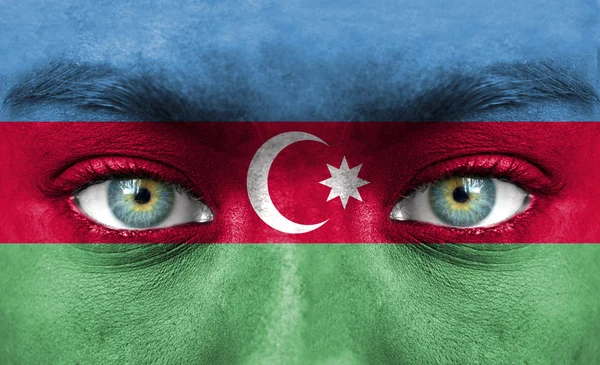 Human face painted with flag of Azerbaijan — Stock Photo, Image