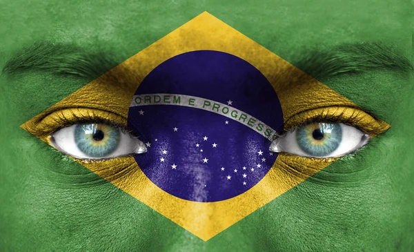 Human face painted with flag of Brazil — Stock Photo, Image