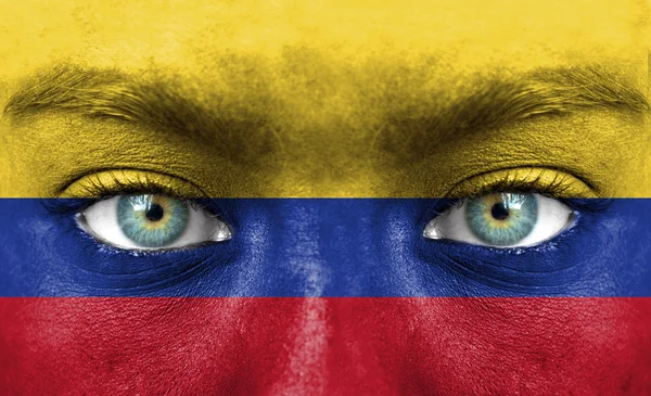 Lidská tvář s vlajka Kolumbie — Stock fotografie