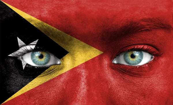Lidská tvář s vlajka Východního Timoru — Stock fotografie